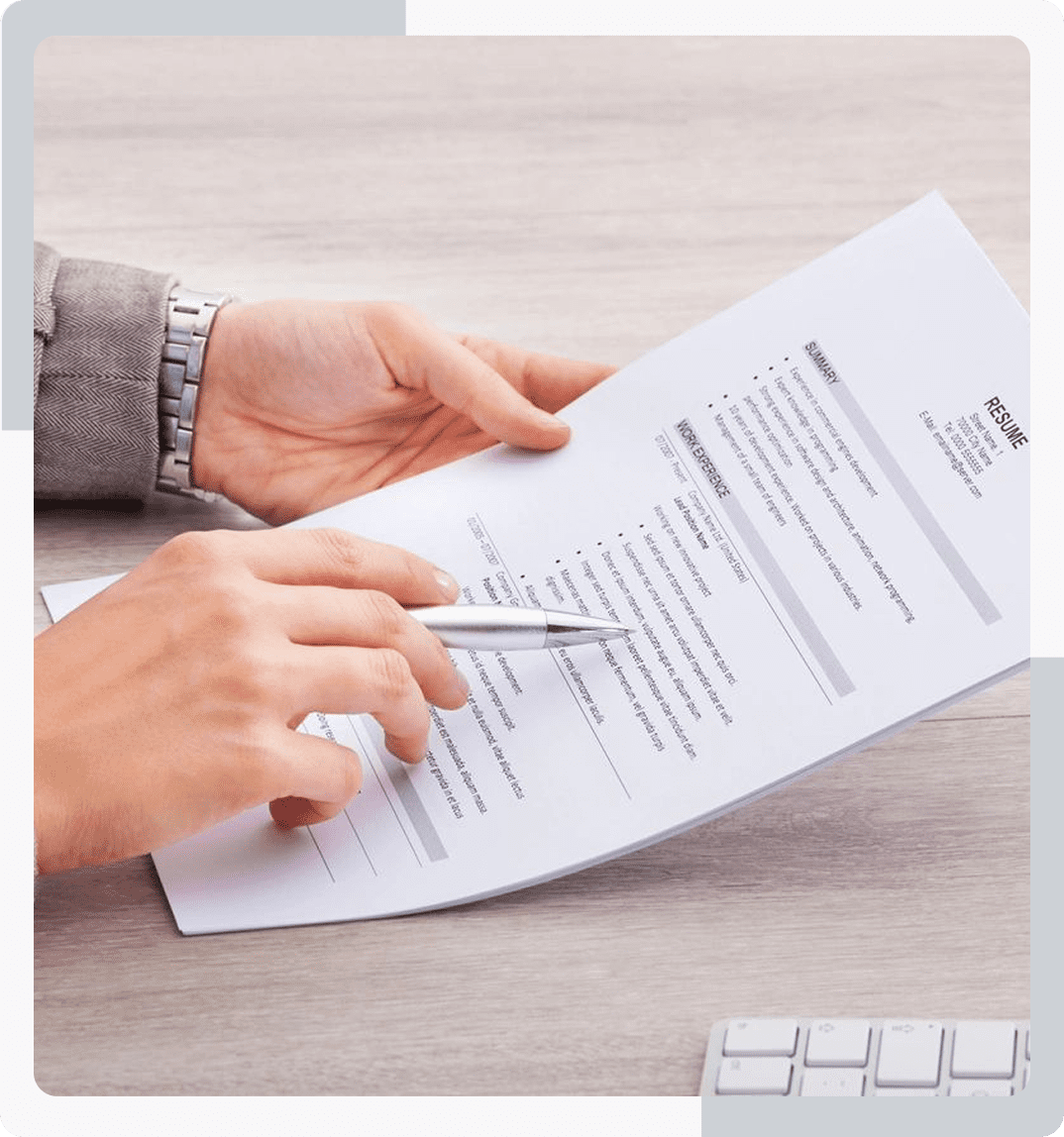 Group 123 A person holding papers and writing on paper